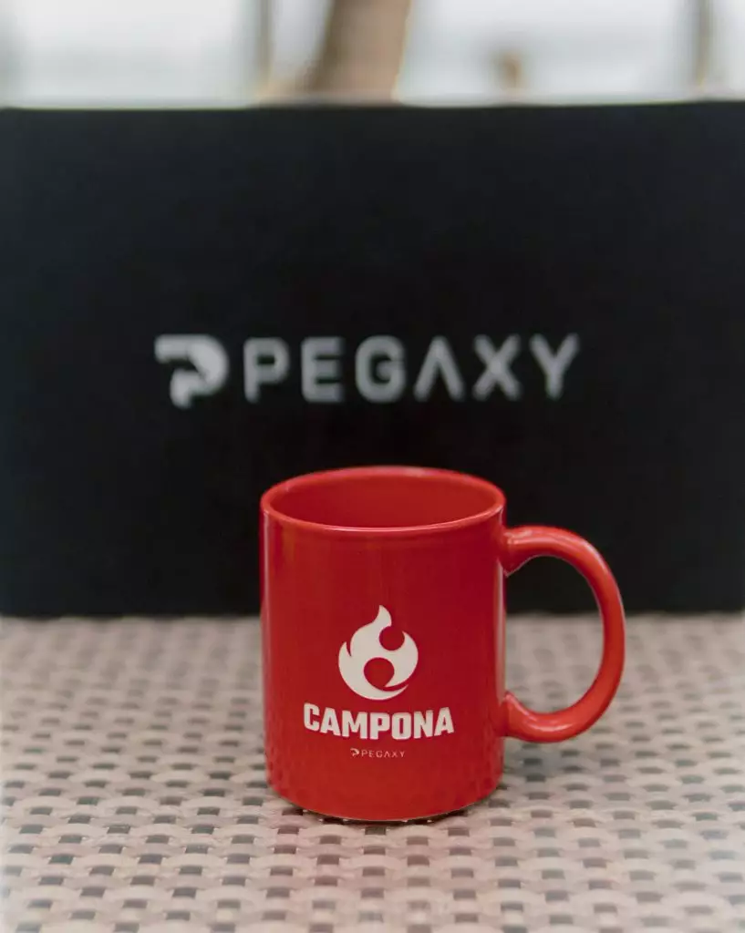 A red Campona mug from the merch box